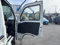 A 2010 Daihatsu Hijet with an open driver's side door showing the interior design and door panel details
