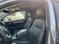 Interior of a 2018 Toyota Highlander featuring black leather seats with a center console and dashboard display