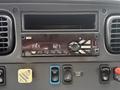 A dashboard stereo display showing FM radio and various control buttons in a 2019 Freightliner M2