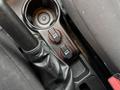 Close-up of the center console in a 2017 RAM ProMaster City showing two red power outlet switches and a gear shifter