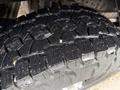 A close-up of a rugged tire tread from a 2008 Ford F-250 SD showcasing deep grooves and a robust design for enhanced traction