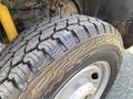 Close-up of a tire on a 2017 Ford F-250 SD with a rugged tread pattern and silver wheel rim