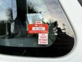 A red and white inspection sticker on the window of a 2013 International Durastar 4300 displaying details of approval and expiration dates