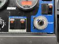 Control panel of a 2009 UD Trucks UD 3300 featuring switches for pickup head controls and a dial for broom pressure