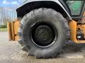 A close-up view of a large black tire mounted on a 2005 Case 570 tractor showcasing the tread pattern and wheel rim