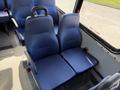 A 2020 Chevrolet Express with blue fabric seats arranged in a row facing forward with a seatbelt on each seat