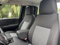 Interior of a 2011 Chevrolet Colorado featuring two front seats with gray fabric upholstery and a central armrest between them