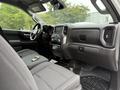 Interior view of a 2022 GMC Sierra 1500 showing a modern dashboard with a central touch screen and comfortable seating in a spacious cabin