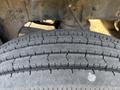 A close-up of a tire from a 2011 Autocar Xpeditor showing the tread pattern and surface detail