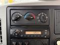Dashboard controls of a 2013 International Durastar 4300 featuring climate knobs and a radio display showing the time as 126 PM
