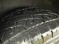 Close-up of a tire from a 2019 Jeep Grand Cherokee showcasing its rugged tread pattern and surface details