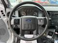 Steering wheel of a 2017 Ford F-750 featuring the Ford logo and various control buttons on the left side