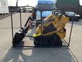 A 2025 AGT MX-MZT14 Mini Loader with a yellow body and black tracks showcased in a protective frame
