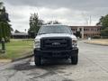 A 2013 Ford F-250 SD facing forward with a black grille and front bumper in a light color