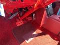 Interior view of a 1962 Ford 2WHDR showing the red carpet floor red pedals and floor mats with a red steering column and dashboard components