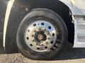 Close-up of a silver wheel with multiple lug nuts and a textured black tire labeled Goodyear on a 2022 Lion Lion6 vehicle