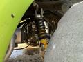 Close-up view of the suspension system of a 2015 Tennant 636 Green Machine showcasing the coil springs and shock absorbers