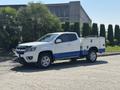 A white 2017 Chevrolet Colorado with blue accents equipped with a utility bed and tools in the truck's bed