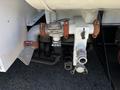 A close-up of a 2008 International DuraStar truck's rear plumbing system featuring various pipes, valves, and connectors