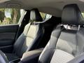 Interior of a 2021 Toyota C-HR featuring two front seats with black fabric and leather accents and a central console between them