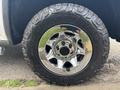 A close-up of a chrome wheel with a Goodyear tire featuring rugged tread patterns, mounted on a 2016 GMC Sierra 1500