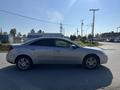 A silver 2006 Pontiac G6 parked on the side of the road with a sleek design and five-spoke wheels