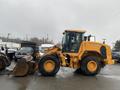 A yellow 2016 Hyundai HL940 wheel loader with a large bucket in the front and heavy-duty tires positioned to the side