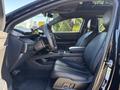 A 2023 Fisker Ocean interior featuring a black leather front seat and steering wheel with a modern dashboard visible in the foreground