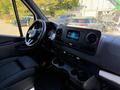 Interior view of a 2023 Mercedes-Benz Sprinter 2500 featuring a modern dashboard with digital display and central infotainment system along with cup holders and steering wheel
