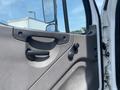 The interior door panel of a 2017 Freightliner M2 106 showing the handle and knobs for window and door operation