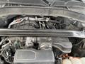 A 2021 Ford Explorer engine compartment showing various components including hoses and an air intake system