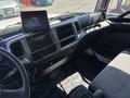 Interior dashboard of a 2020 Hino 338 featuring a steering wheel touchscreen display and various controls and knobs