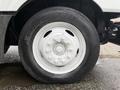 Close-up of a white wheel with a central hub surrounded by a black tire labeled STRONG ARM