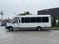 A 2018 Chevrolet Express van with a modified body for passenger transport featuring large windows and a streamlined roof design