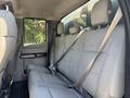 Interior view of a 2017 Ford F-550 showing the rear seating area with grey fabric seats and seatbelts