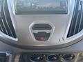 Dashboard of a 2017 Ford Transit-350 featuring a car stereo and control knobs for climate settings