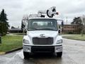 A 2005 Freightliner M2 106 truck with a white body and an elevated work platform mounted on the back facing forward