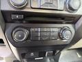 The dashboard controls of a 2018 Ford F-150 featuring buttons for air conditioning ventilation and temperature adjustment