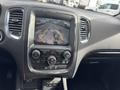 Interior view of a 2015 Dodge Durango showing a dashboard display with a rear-view camera feed and control buttons for audio and climate settings