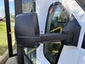Side mirror of a 2017 Chevrolet Express van with a focus on the sleek black design and sturdy mounting на the body of the vehicle