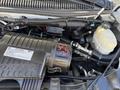 Engine compartment of a 2017 Chevrolet Express showing the air intake system various hoses and components