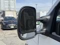 Side mirror of a 2008 Ford Econoline reflecting a nearby vehicle with a clear view of its surface