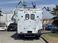 A 2008 Workhorse W62 parked with a silver metallic body and various equipment attached to the roof including ladders and safety lights