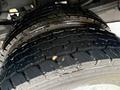 Close-up of the tread pattern on two large tires of a 2024 RAM 5500 showing deep grooves and a rugged design