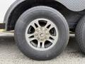 A close-up of a silver alloy wheel with multiple spokes mounted on a black tire labeled Road Rider ST