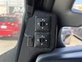 A control panel featuring window control buttons for left and right doors and a lock switch in a 2020 Chevrolet Express