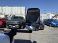 A 2020 Chevrolet Express van with a side mirror prominently displayed in the foreground