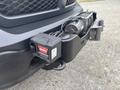 A 2016 RAM 1500 front bumper with a mounted WARN M8000 winch and control box attached to it
