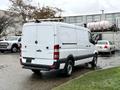A white 2017 Mercedes-Benz Sprinter van with a high roof and dual rear doors parked in a lot