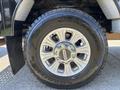 Close-up of a 2022 Ford F-350 SD tire featuring a shiny alloy wheel with a Goodyear Wrangler tire mounted on it